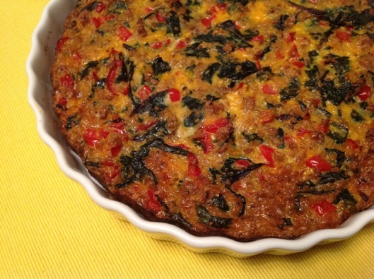 Golden brown egg frittata with green and red colours